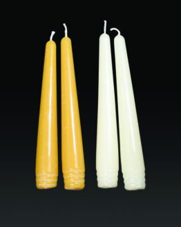 A pair of gold and white six inch taper candles