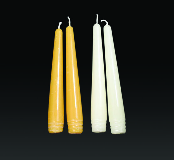 A pair of gold and white six inch taper candles