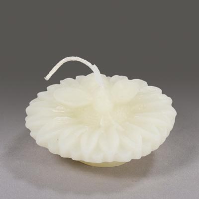 A white floating bee shaped candle