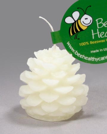 A small white pinecone shaped candle