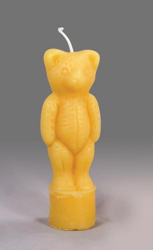 A gold standing bear shaped candle