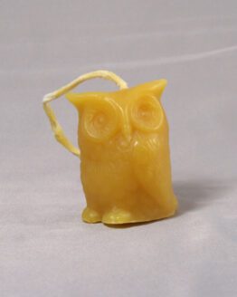 A gold owl shaped beeswax candle