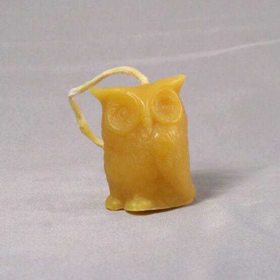 A gold owl shaped candle