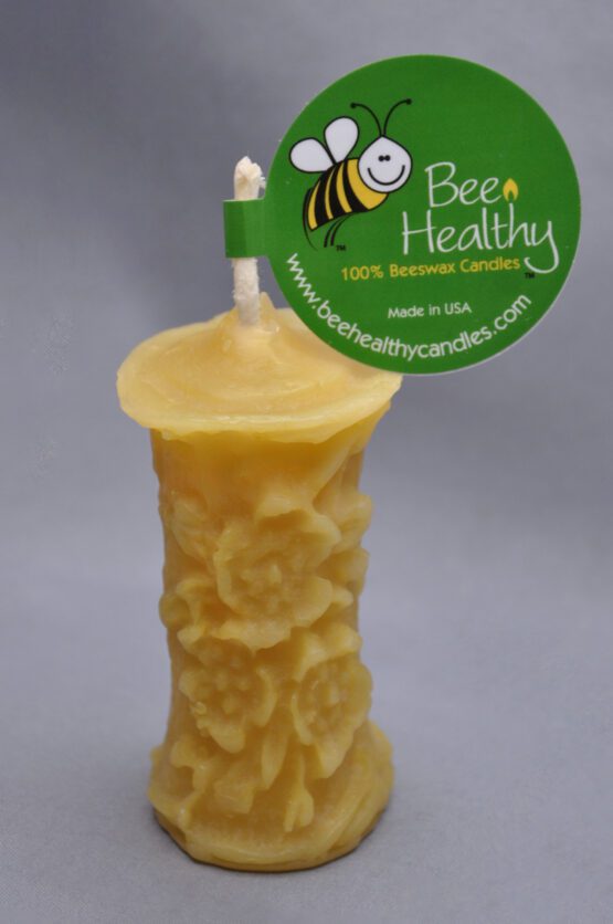 A smaller image of a small gold flower pillar candle with a label
