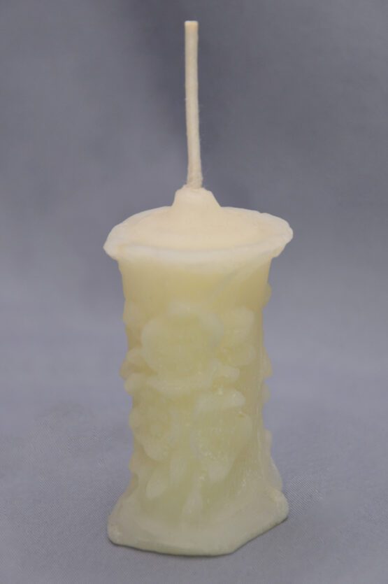 A small white flower pillar candle